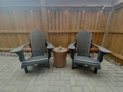 two chairs sitting on a patio with a table at The 1883 Century Flat Suite in Collingwood