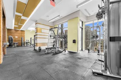 a gym with treadmills and weights in a building at Estate 1 Bedroom Condo Front Street West in Toronto