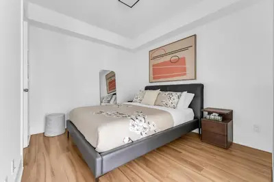 a bedroom with a bed and a wooden floor at Estate 1 Bedroom Condo Front Street West in Toronto