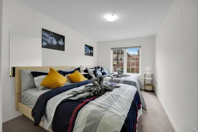a bedroom with two beds and a window at Spacious Family Friendly Vacation home in Brampton