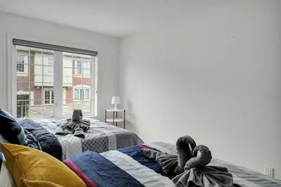 a bedroom with two beds and a window at Spacious Family Friendly Vacation home in Brampton