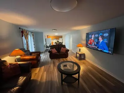a living room with a large flat screen tv on the wall at Travelers Home in Oshawa