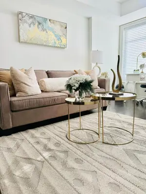 a living room with a couch and two tables at Dufferin Serenity Suite in Toronto