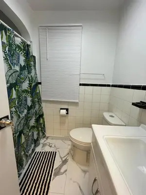 a white bathroom with a toilet and a sink at Toronto Room with Balcony - Midtown in Toronto