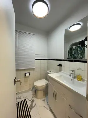 a bathroom with a toilet and a sink and a mirror at Toronto Room with Balcony - Midtown in Toronto