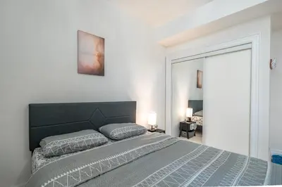 a bedroom with a large bed and a large window at Frybrook in Richmond Hill