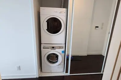 a washing machine and a dryer in a room at Modern studio High Floor ,CN Tower, ScotiaArena in Toronto
