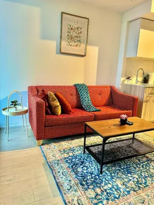a living room with a red couch and a table at Elegant Condo Near Eaton Centre Mall in Toronto