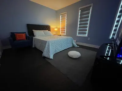 a bedroom with a bed and a chair and a television at Finesse in Whitby