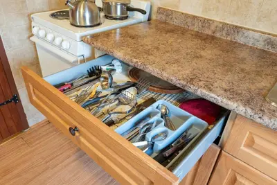 an open drawer in a kitchen with a sink at Peaceful Getaway in Bailieboro