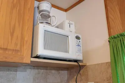 a microwave with a cup on top of it at Enjoy the Outdoors in Bailieboro