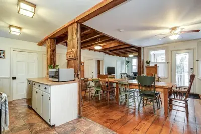 a kitchen and dining room with a table and chairs at The Marigold - Gorgeously remodelled PEC farmhouse in West Lake