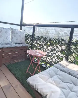 a patio with a couch and a table on a balcony at KozyStay Toronto in Toronto