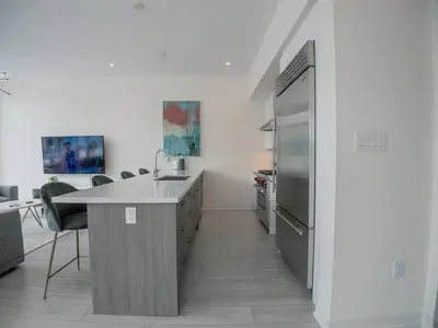 a kitchen with a sink and a refrigerator at Casa Lago 5 Bed Waterfront House in Innisfil