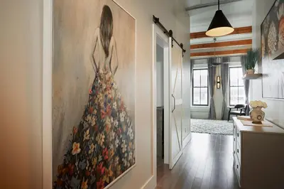 a painting of a woman in a dress on a wall at L'auberge De France Inn in Belleville