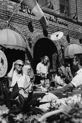 a group of people sitting at a table at L'auberge De France Inn in Belleville