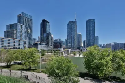 a tennis court in front of a city skyline at Stylish Condo Downtown Near CN Tower - Free parking in Toronto