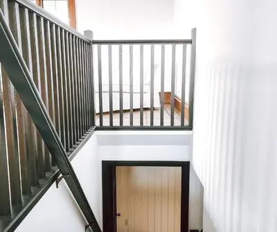 a stairway with a wooden door in a building at Cellar Suite at Winery and Vineyard in Waterford