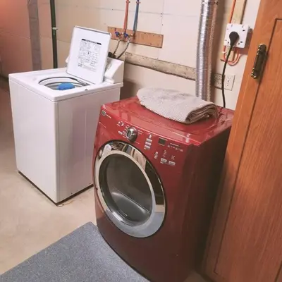 a washing machine sitting next to a washer at Cellar Suite at Winery and Vineyard in Waterford