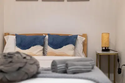 a bed with blue and white pillows and a lamp at Beautiful 2 Bedroom Downtown Toronto Condo with free parking in Toronto