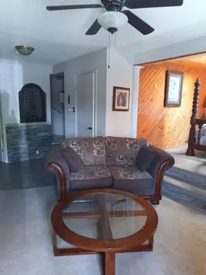 a living room with a couch and a coffee table at Princess Motel in Bobcaygeon