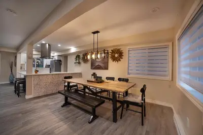 a dining room and kitchen with a table and chairs at Muskoka Waterfront Cottage - Moon River with HOT TUB in Bala