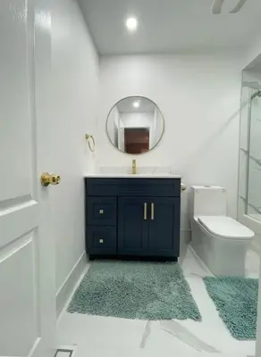 a bathroom with a sink and a mirror and a toilet at Elegant & Luxurious 3 Bedroom Home in Mississauga