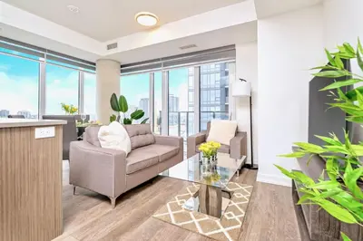a living room with a couch and a table at Condo Unit with Stunning Views & Amenities in Kitchener