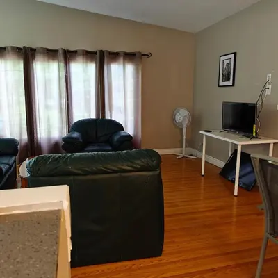 a living room with a couch and a desk at Lina's Place1 in St. Catharines