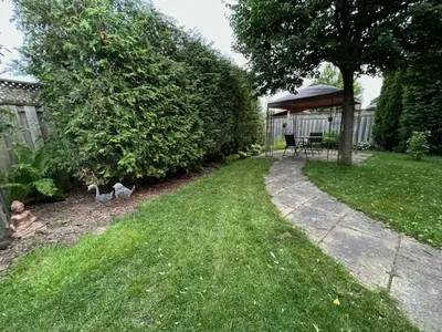 a garden with a gazebo and two birds in the grass at Maya Bed and Breakfast in Port Perry