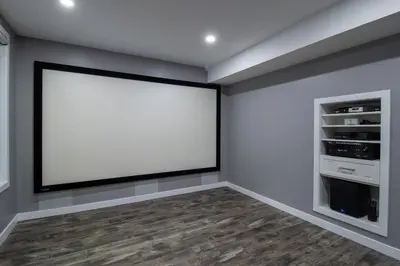 an empty room with a large white screen on the wall at The Gate Chic & Cozy Basement Retreat in Ajax in Ajax