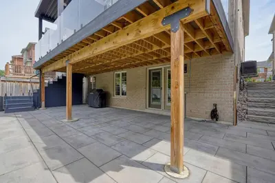 a patio with awning on top of a building at The Gate Chic & Cozy Basement Retreat in Ajax in Ajax