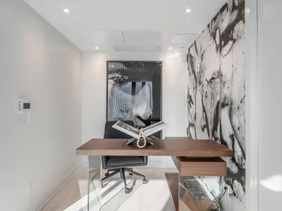 a desk in a room with a mirror at Hazelton Suites - Yorkville - Indoor Pool & Hot Tub in Toronto