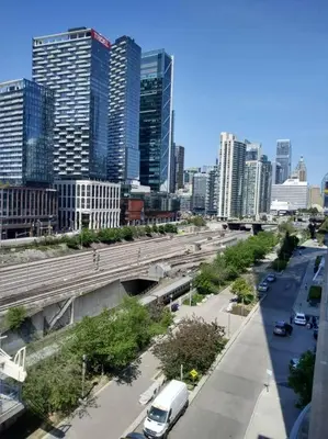 a view of a city with cars on a highway at Downtown City View Escape with Free Parking in Toronto