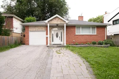a brick house with a white door and a driveway at Stunning Vacation Home North of Toronto in Richmond Hill