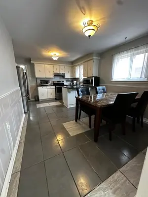a kitchen with a table and chairs and a dining room at 3 Room Set for Up to 8 people- 10 minutes from Kitchener Airport, Walking to Transit in Kitchener