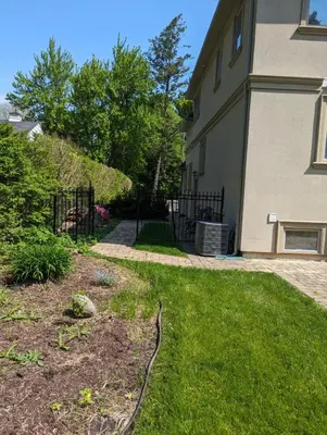a yard with a fence and a house at Luxury Apartment Living in Mississauga