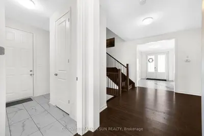 an empty living room with white walls and wood floors at Cozy 5 bedrooms & 5 bathrooms House in Tottenham