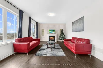 a living room with two red couches and a fireplace at Cozy 5 bedrooms & 5 bathrooms House in Tottenham
