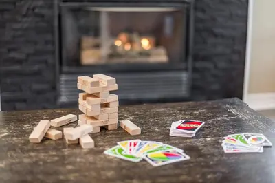 a stack of wooden blocks on a table with a fireplace at PetFriendly, 2 KingBeds, Gym, Pool, Netflix in Shanty Bay