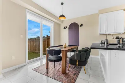 a kitchen with a table and chairs in a kitchen at Spacious Family Getaway Near Nature & Dining in Cambridge