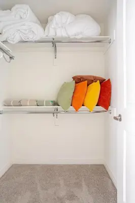 a closet with shelves filled with different colored towels at Stylish 4br Fast Wifi Sleeps 10 in Barrie