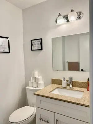 a bathroom with a toilet and a sink and a mirror at Private Room Near Airport K3 in Mississauga