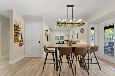 a kitchen and dining room with a table and chairs at Spruce Suite in Niagara on the Lake