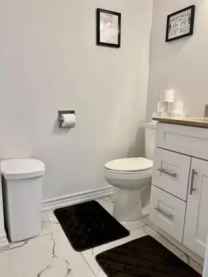 a white bathroom with a toilet and a sink at Private Room Near Airport K9 in Mississauga