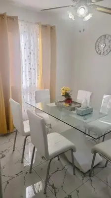 a dining room with a glass table and white chairs at Private Room Near Airport K4 in Mississauga