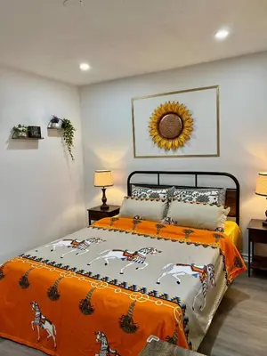 a bedroom with a bed with a sunflower on the wall at Private Room Near Airport K2 in Mississauga