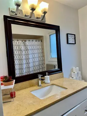 a bathroom with a sink and a large mirror at Private Room Near Airport K2 in Mississauga