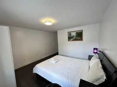 a small bedroom with a white bed and a lamp at Riverwood Home-Entire Rental Unit in Mississauga
