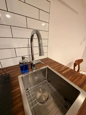 a kitchen sink with a faucet on top of it at Lower level newly renovated studio apartment in central downtown location in Toronto